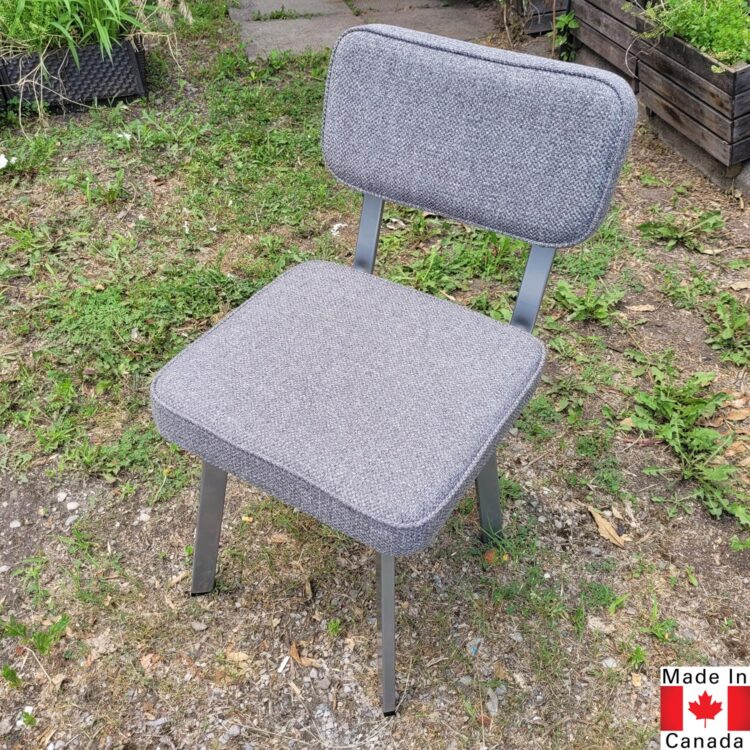Light grey dining chair with a boxy shape.