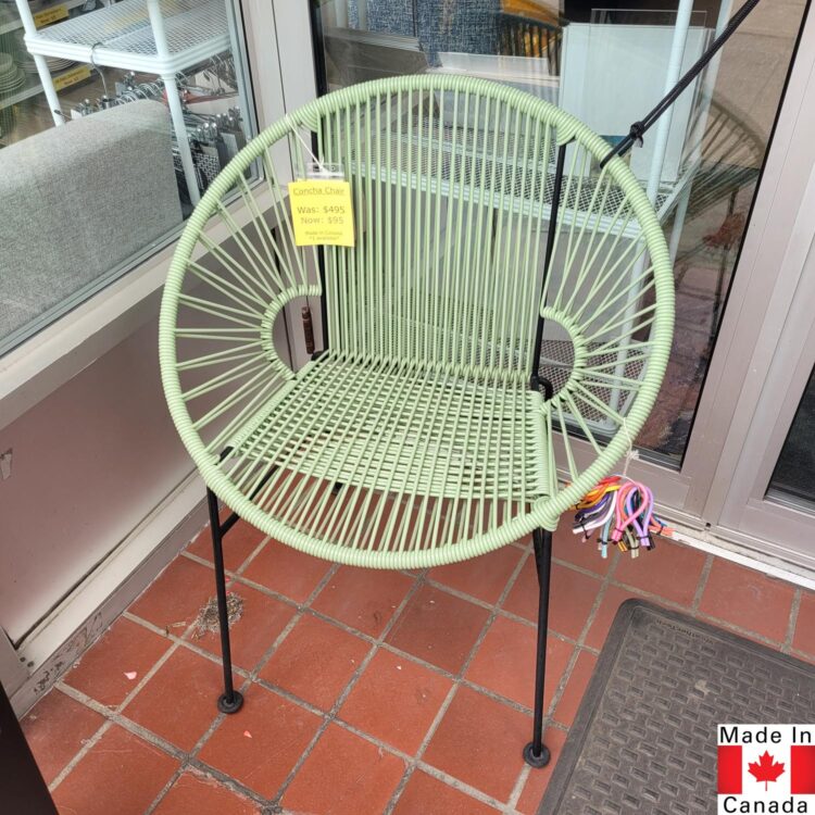 Green woven cord outdoor chair, with black metal base.
