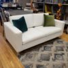 White sofa with square arms and silver metal legs.