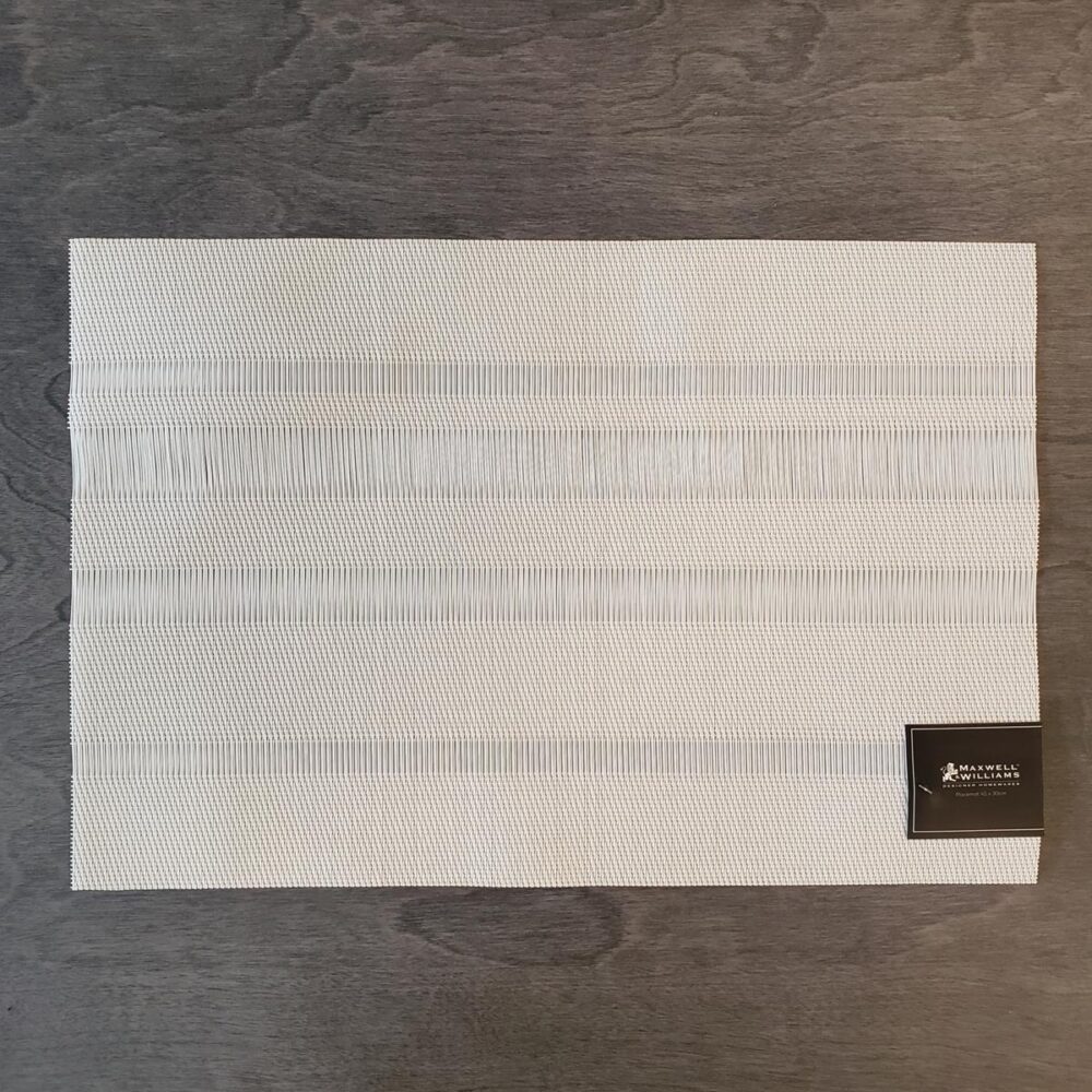 Woven vinyl placemat in creamy off white. Mix of weaves creates four horizontal stripes of varying heights.