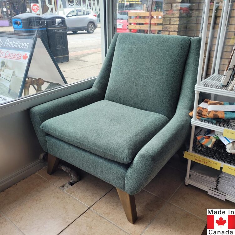 Mid century modern accent chair in muted green upholstery.