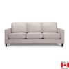 Light grey sofa with 3 seat cushions, and 3 back cushions. Boxy shape, on medium height dark wood legs.