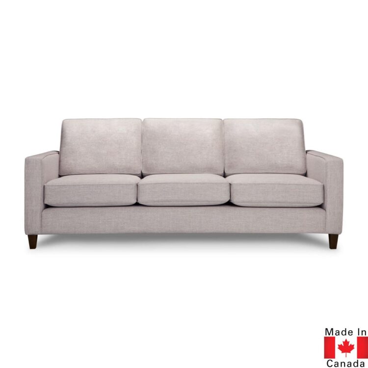 Light grey sofa with 3 seat cushions, and 3 back cushions. Boxy shape, on medium height dark wood legs.