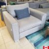 Light grey upholstered chair with deep seat.