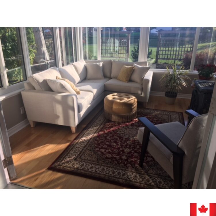 Light grey sectional sofa in a sunny room.