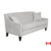 Light grey sofa with slip sloped arm, elevated on dark wood legs.