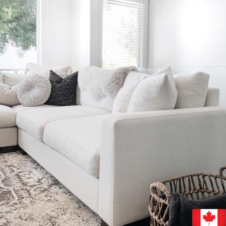 Sectional sofa in light cream fabric.