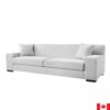 Light grey sofa with 11 inch wide arms, and tight backs. Boxy shape, sits low to the ground.